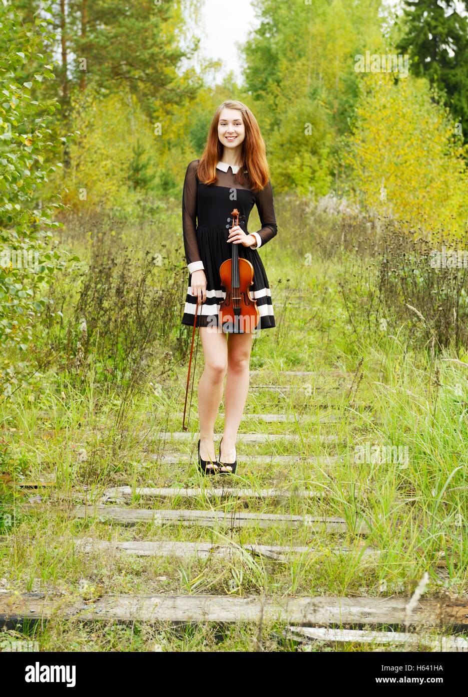 Girl with violin in the forest Stock Photo - Alamy