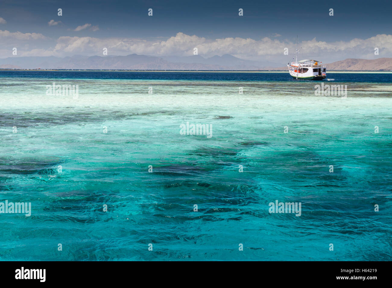 Boat and coral reef area in tropic. Stock Photo