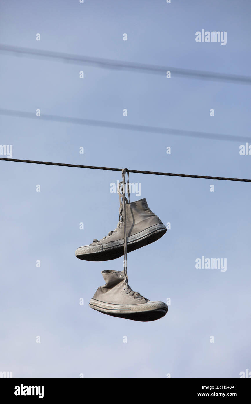 trainers hanging from telephone lines
