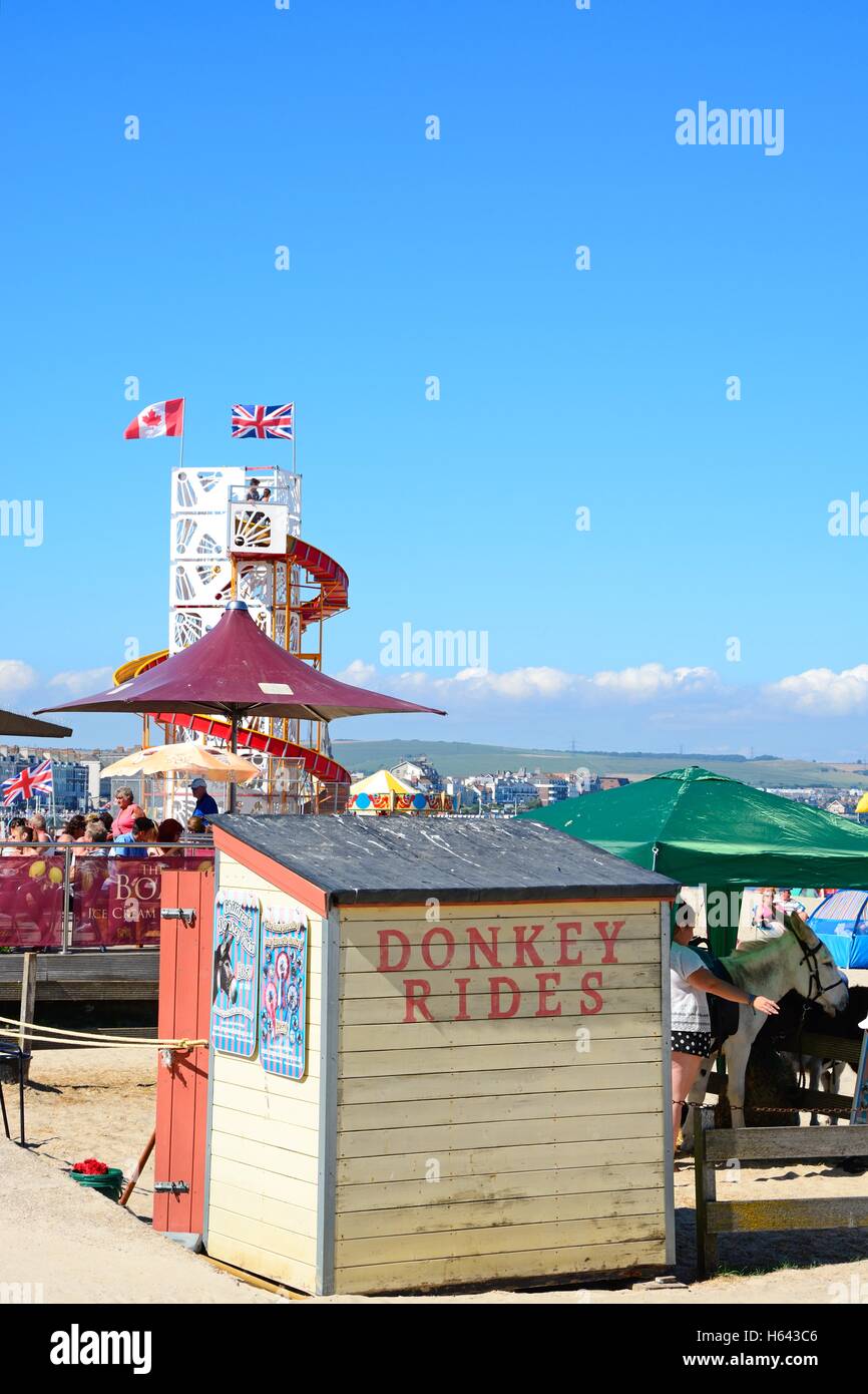 Donkey rides area with a cafe and Helter Skelter to the rear on the beach, Weymouth, Dorset, England, UK, Western Europe. Stock Photo