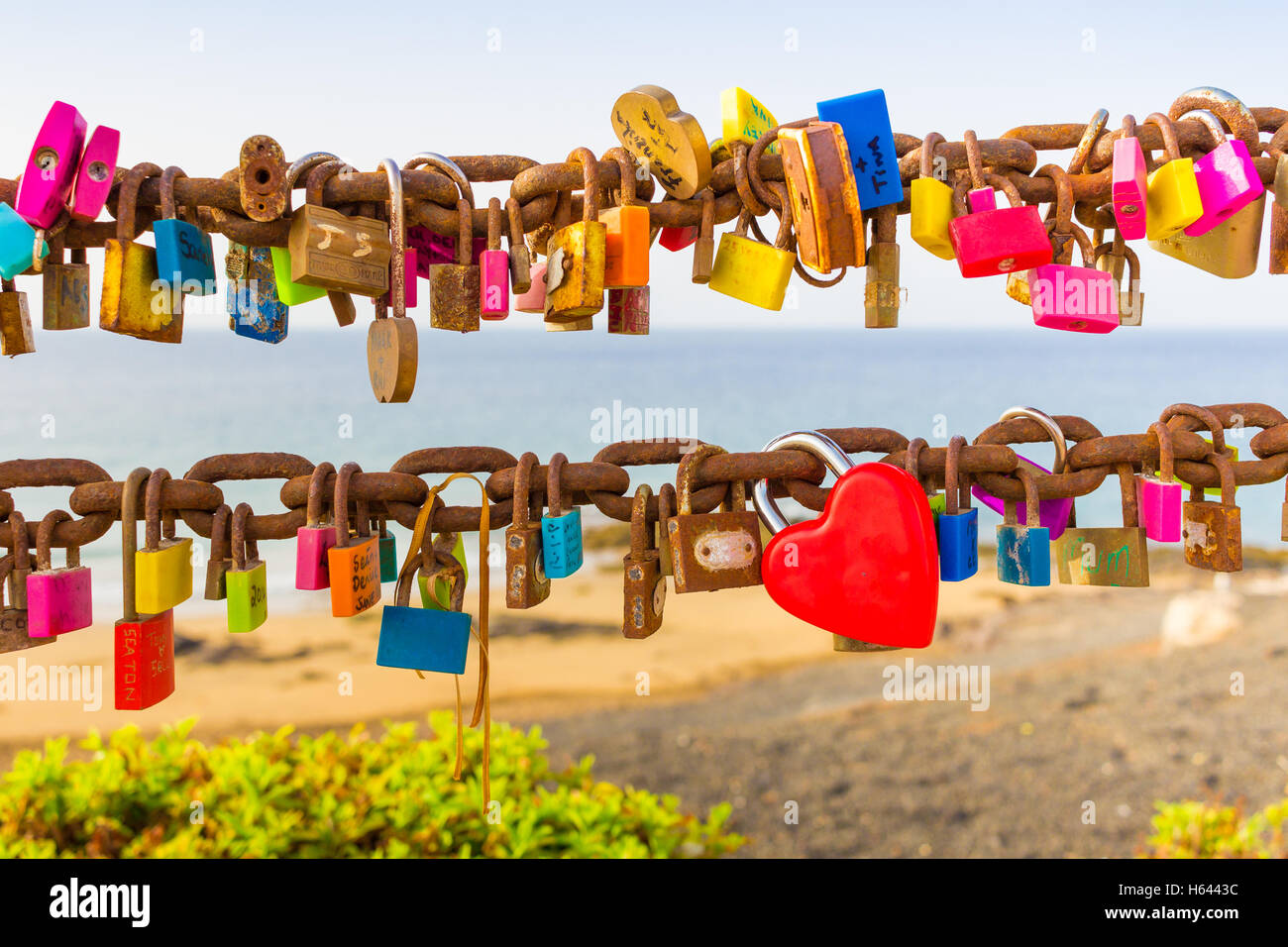Padlocks of love on rusty chain seaview Stock Photo
