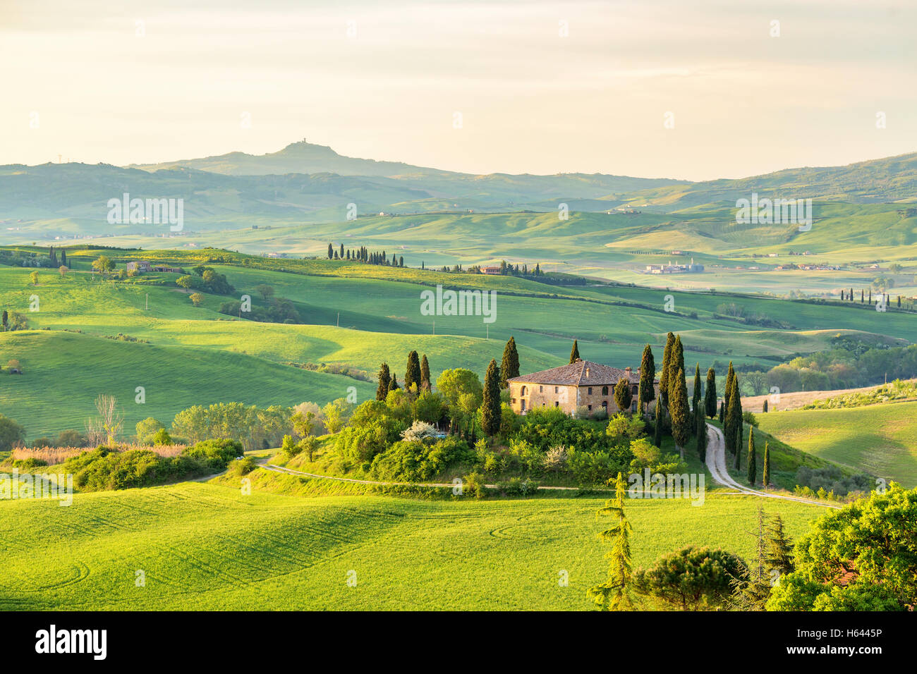 House on a hill in Tuscany landscape Stock Photo - Alamy