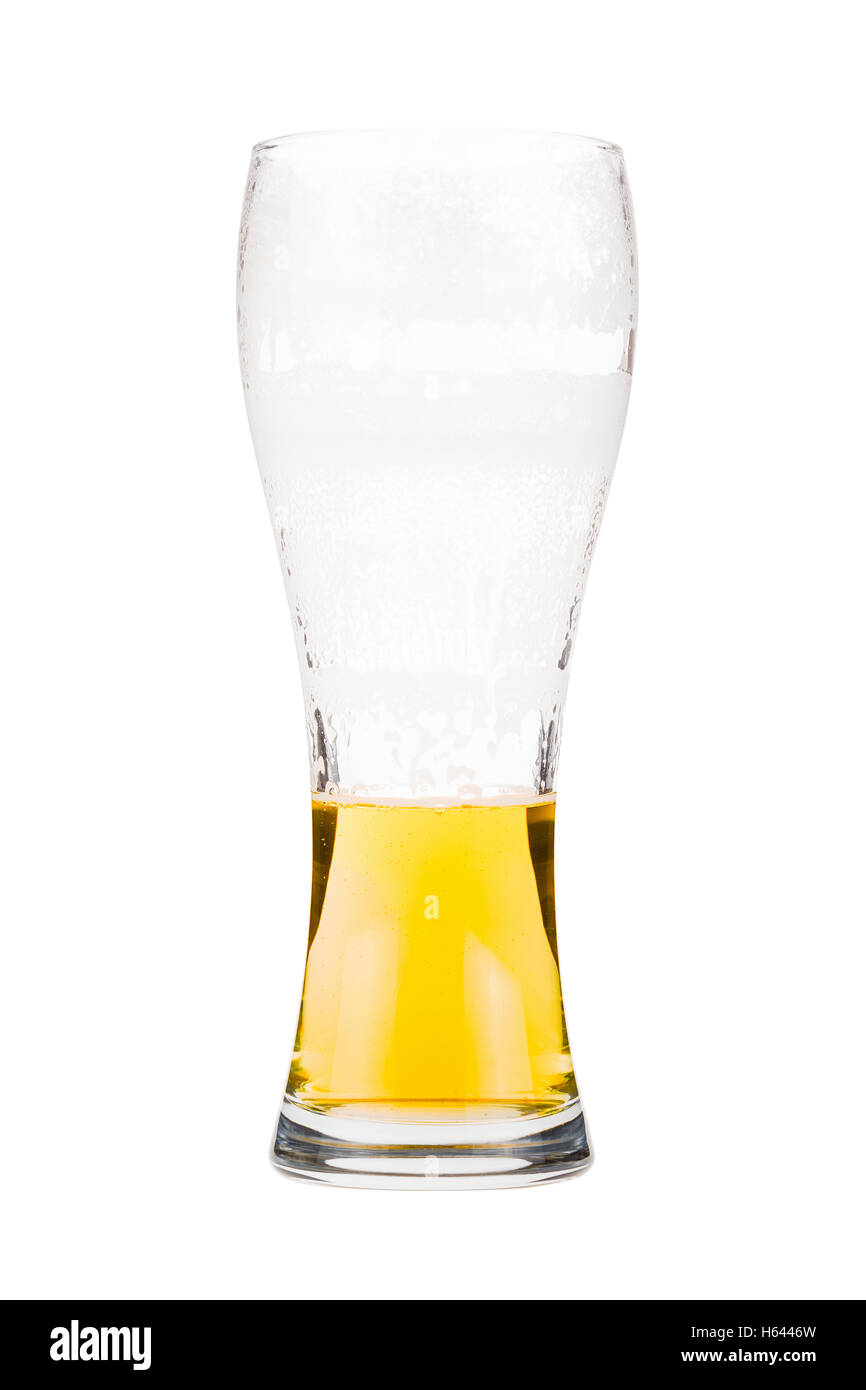 Half full beer glass. Light lager beer remains in a tall glass. Isolated on white background Stock Photo