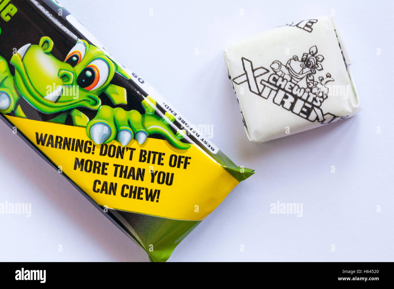 Warning don't bite off more than you can chew - detail on pack of Xtreme Chewits extremely sour apple with one removed Stock Photo