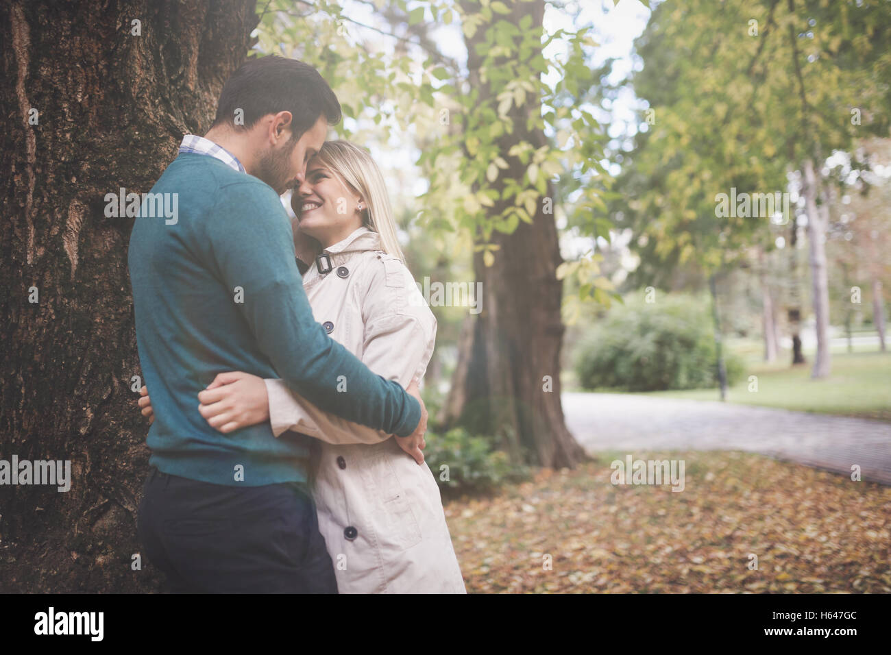Loving happy couple hugging in park Stock Photo - Alamy