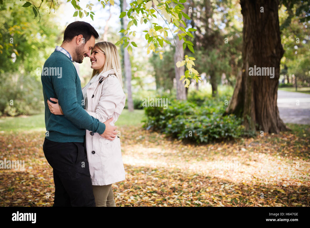 Loving happy couple hugging in park Stock Photo - Alamy
