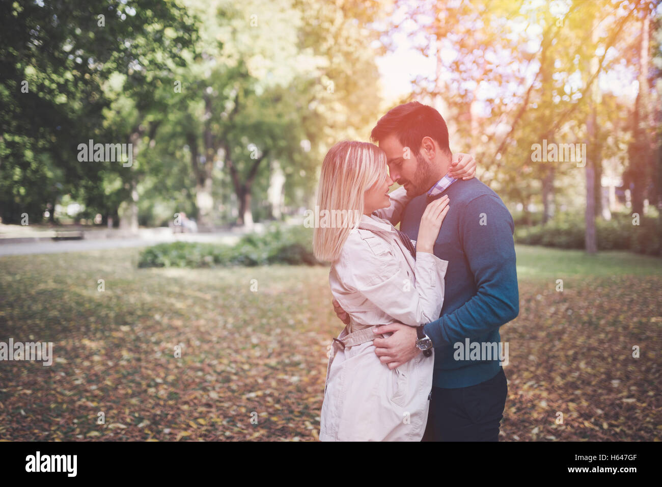 Loving happy couple walking in park Stock Photo - Alamy