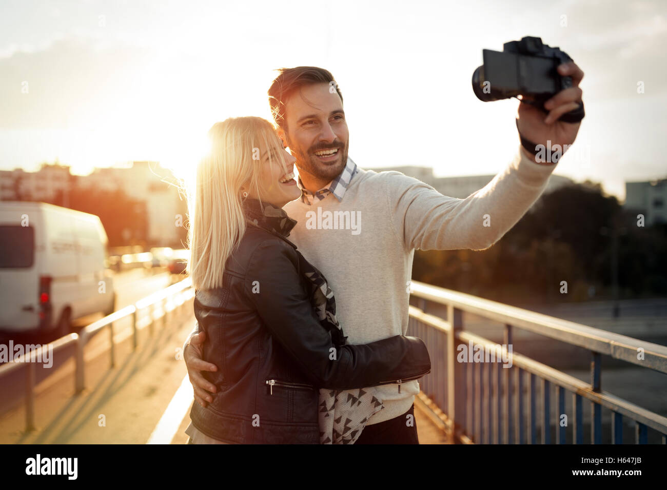 Tourist couple taking selfies during sunset Stock Photo