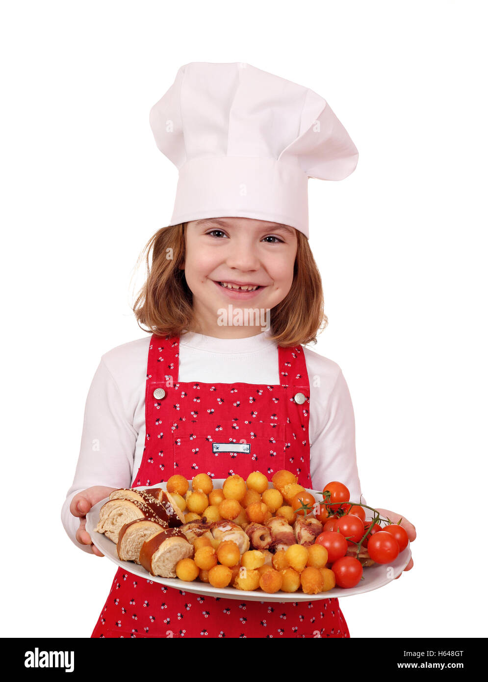happy little girl cook hold plate with gourmet food Stock Photo