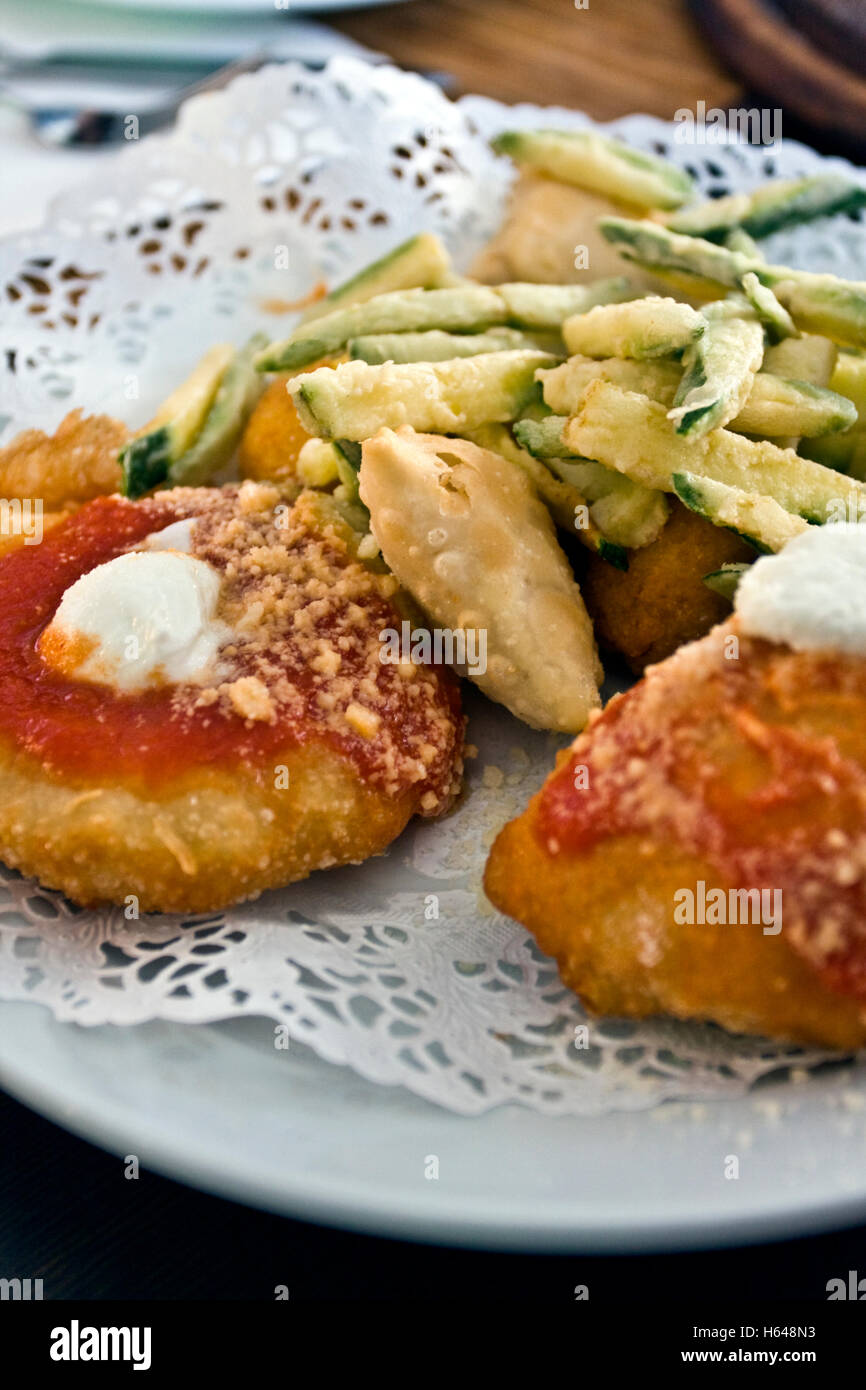 Mix of fried appetizers with Montanara pizza and fried zucchini, Italian fries Stock Photo