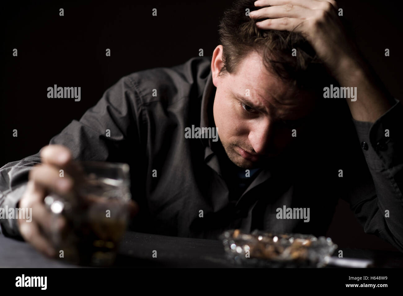 Frustrated man drinking beer Stock Photo