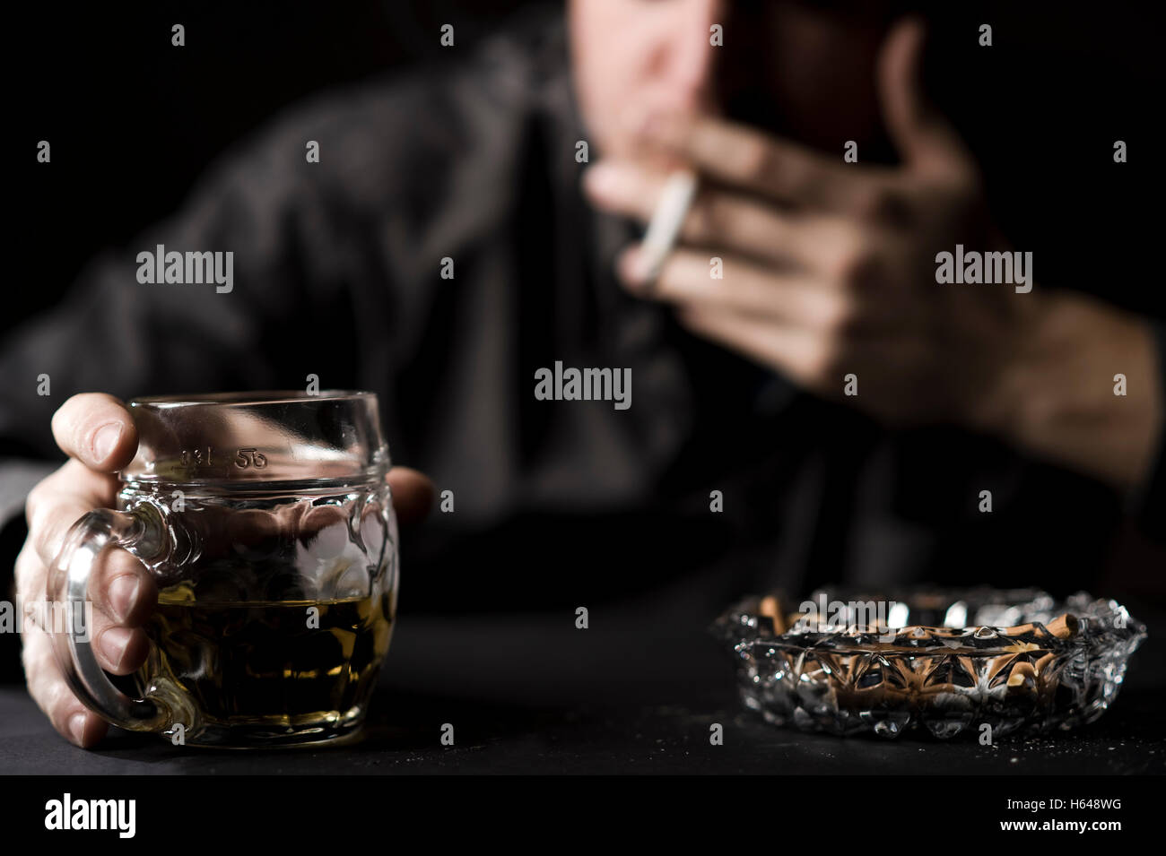 Man with beer and cigarette Stock Photo