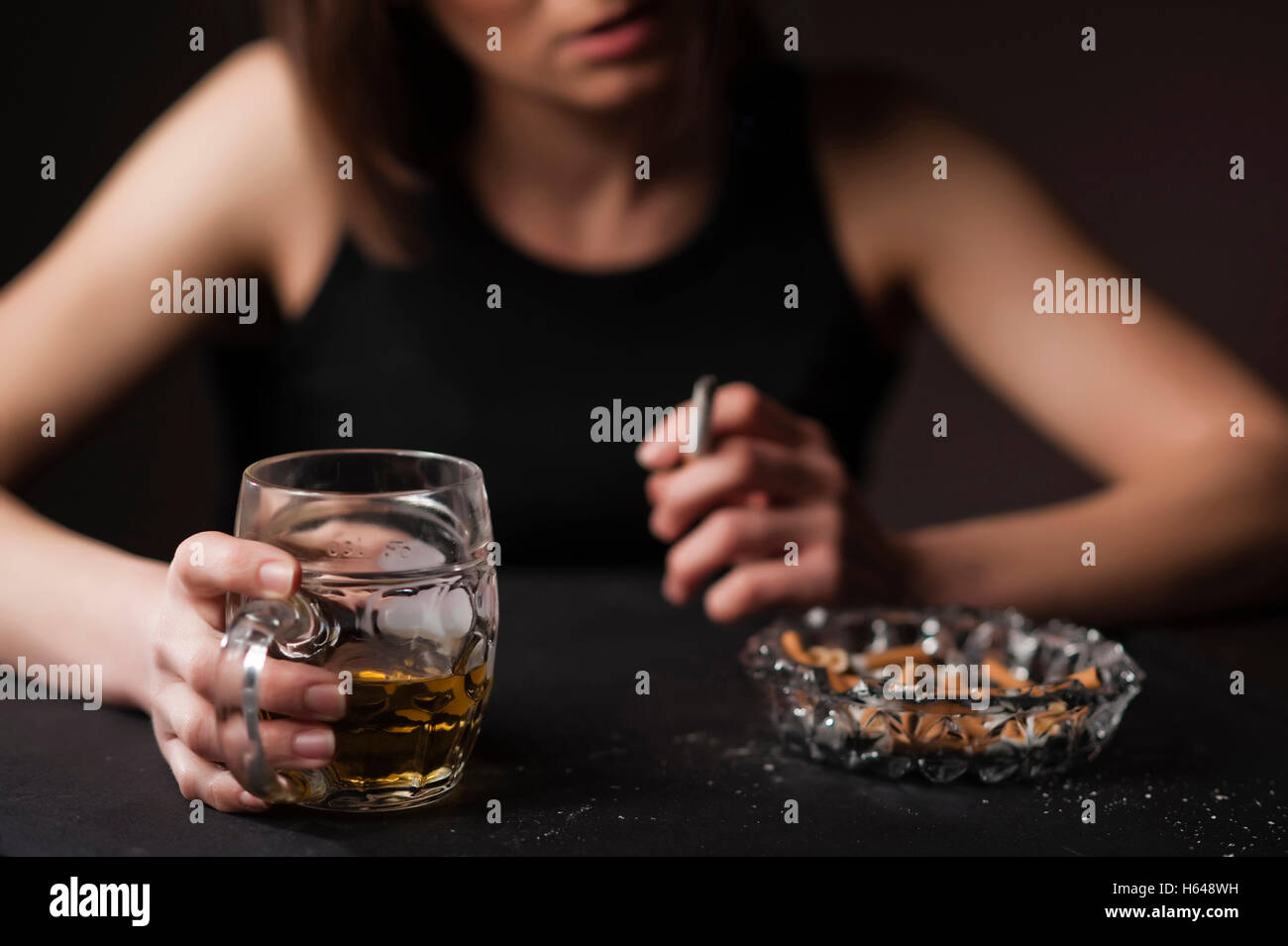 Woman with beer and cigarette Stock Photo