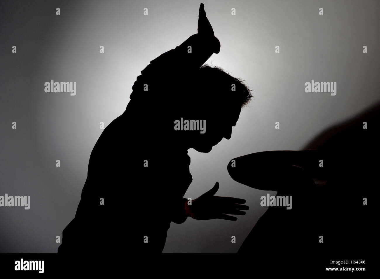 Man beating woman, silhouette Stock Photo