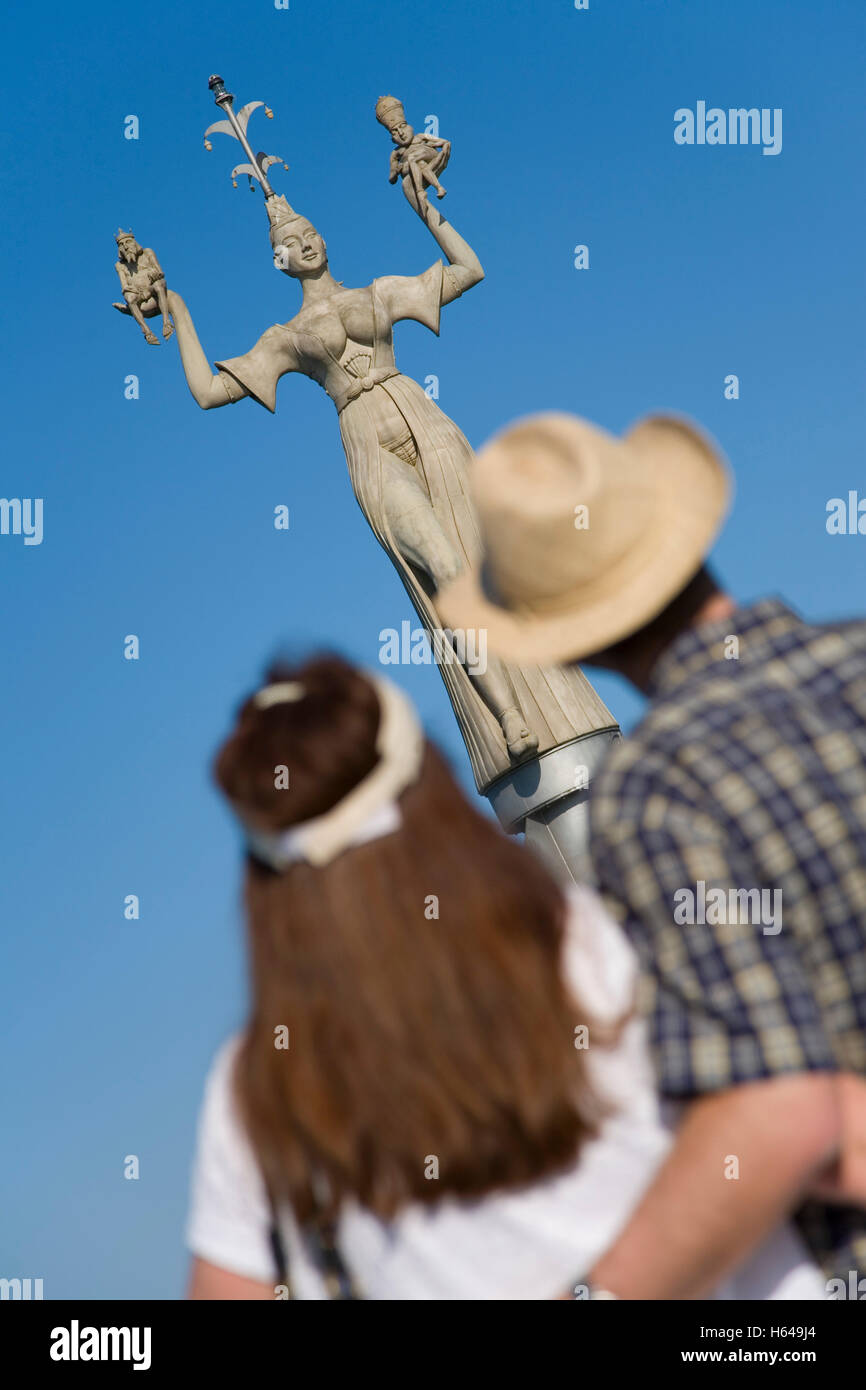 Couple looking at the Imperia statue by sculptor Peter Lenk, port, Konstanz, Baden-Wuerttemberg Stock Photo