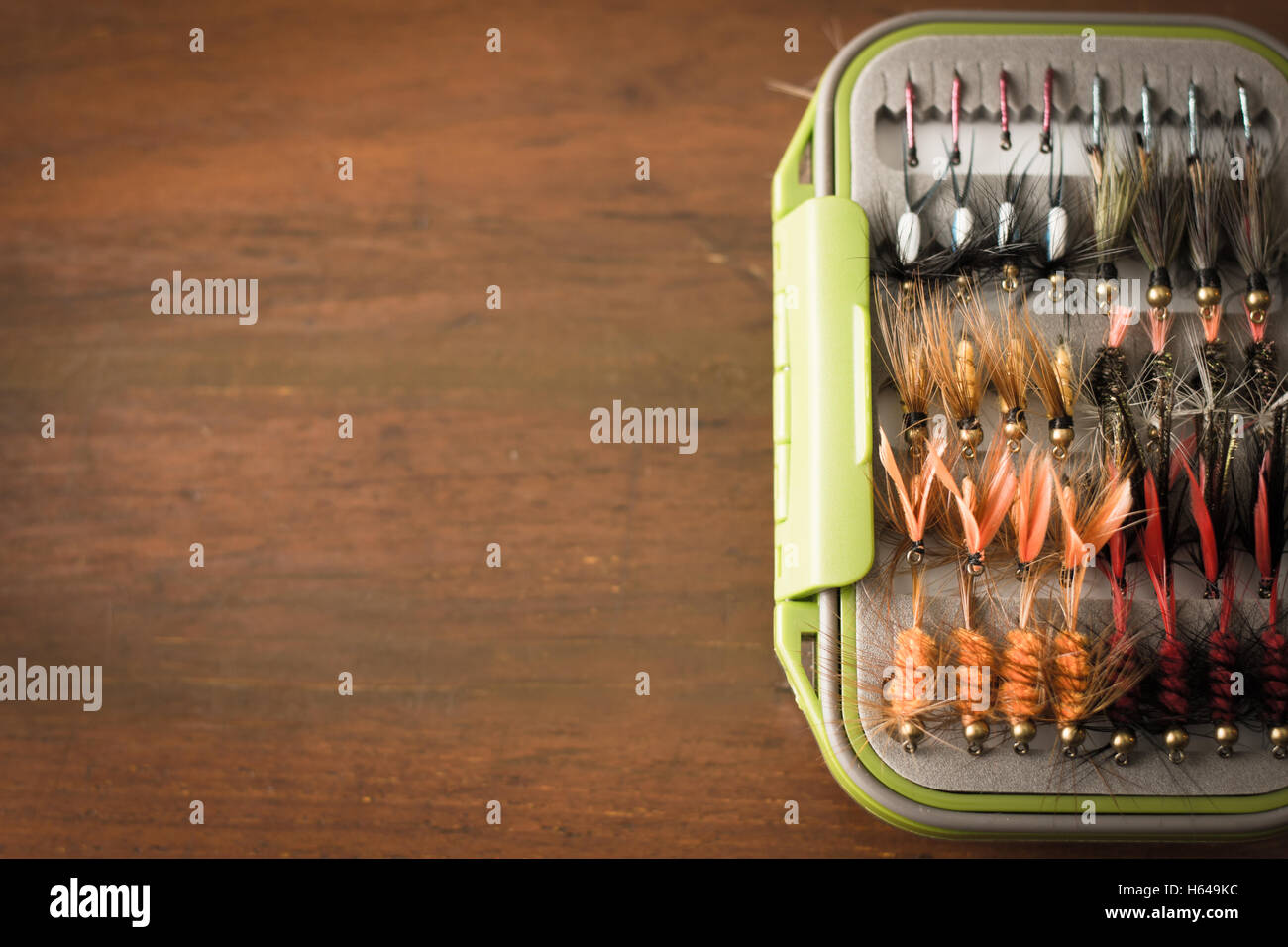 Fly fishing gear, which includes a reel and containers of flies with copy space Stock Photo