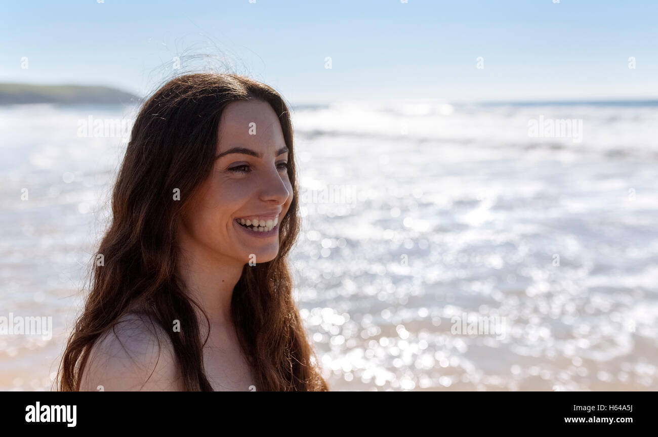 Happy young woman on the beach Stock Photo - Alamy