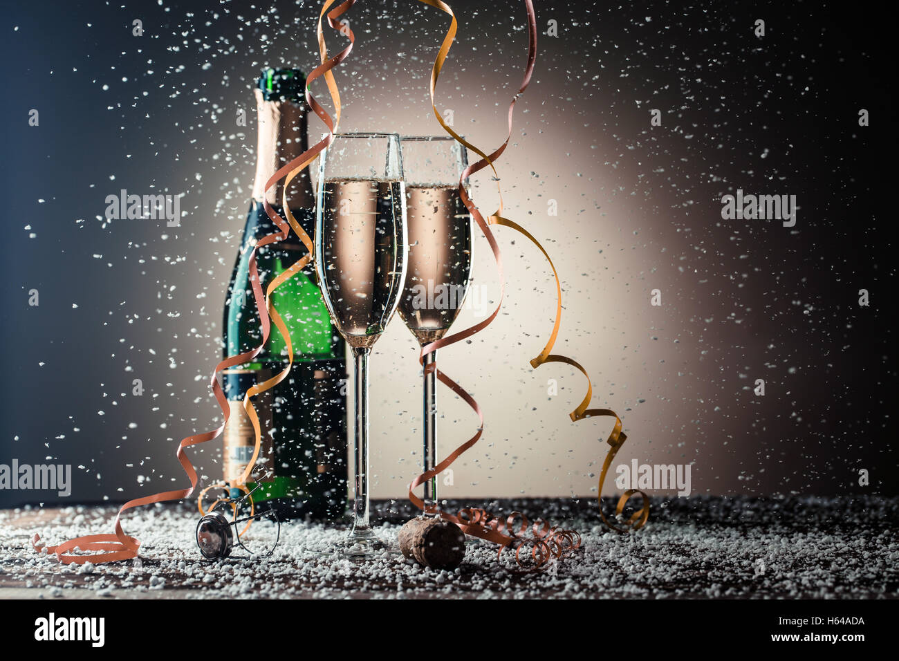 Open bottle of champagne and two filled glasses, festive composition ...