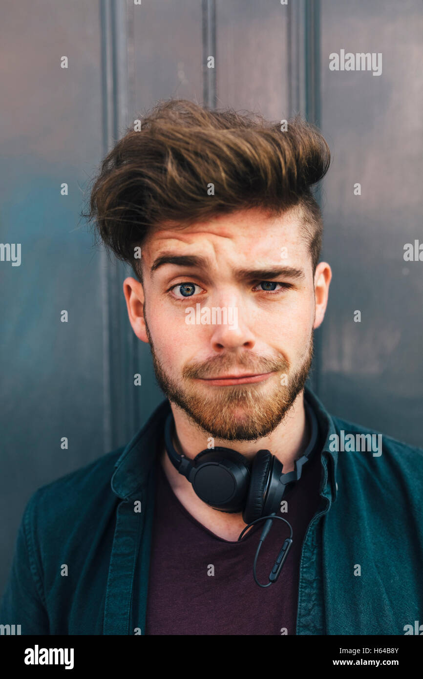 Portrait of young man with quiff pulling funny face Stock Photo