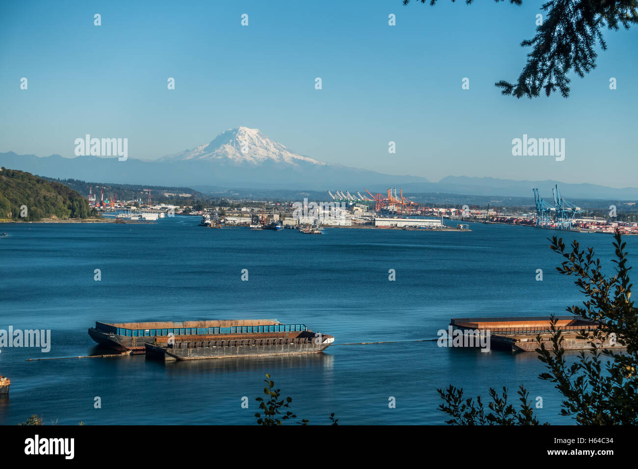 Mount Rainier towers over the Port of Tacoma. Stock Photo