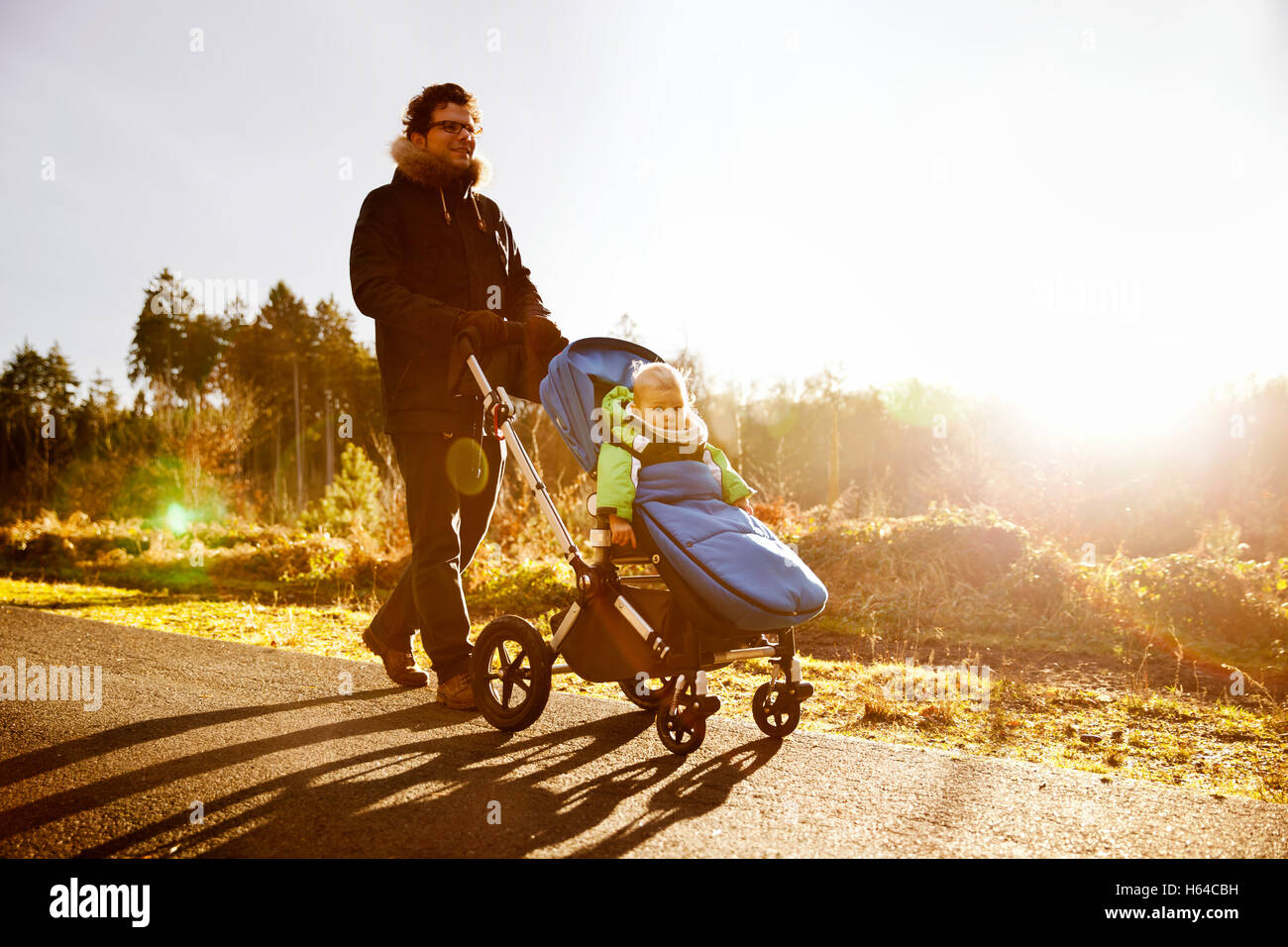 Father and son in buggy on a walk in forest Stock Photo
