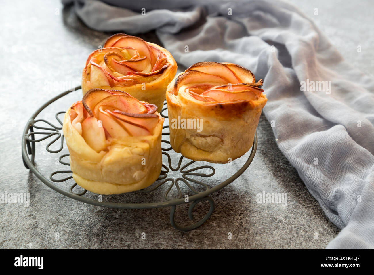 Filo pastry apple cakes in rose shape on cooling grid Stock Photo - Alamy