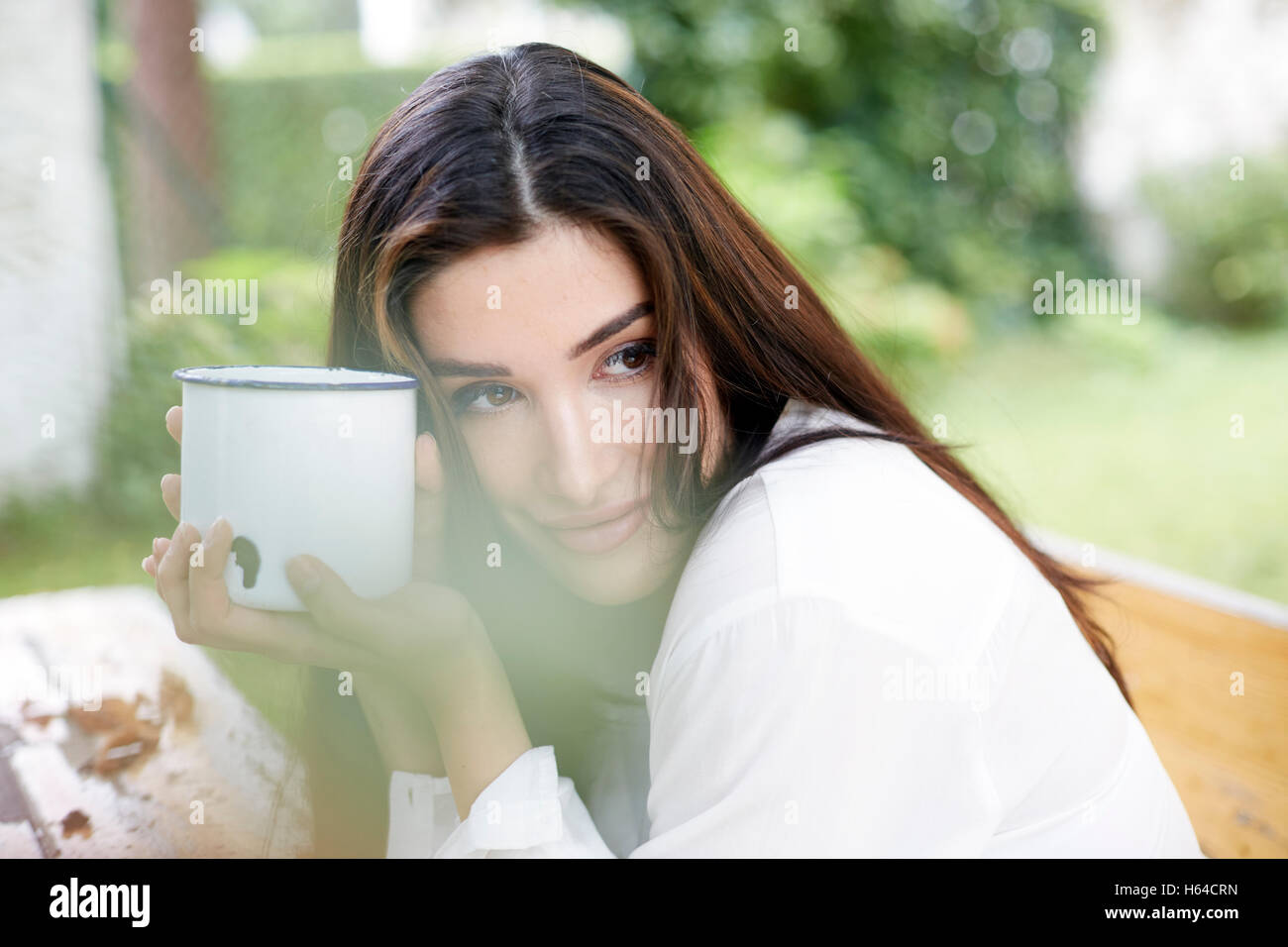 Portrait of smiling woman relaxing with cup of coffee Stock Photo - Alamy