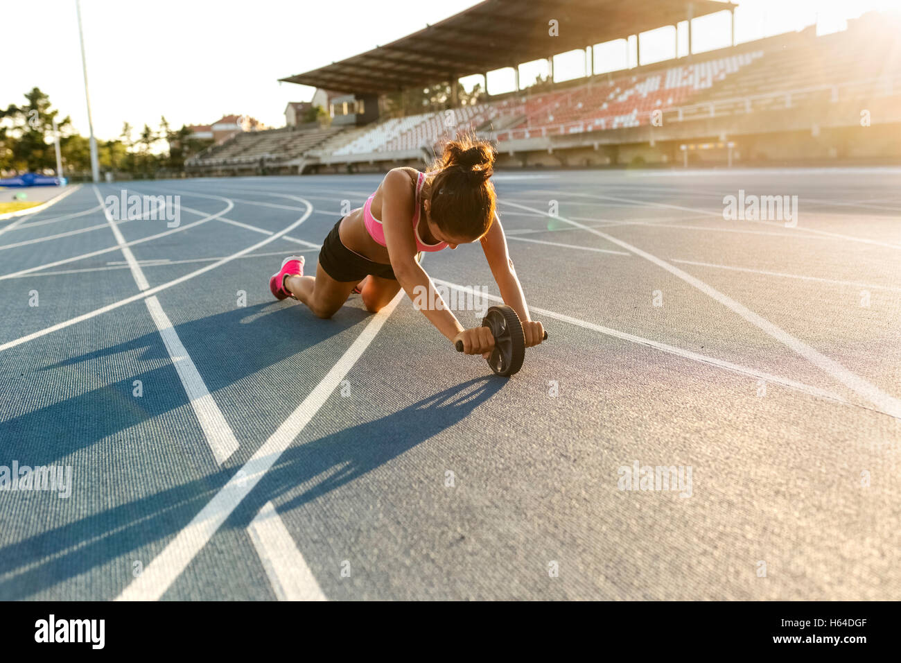 Female athlete doing strength training with a roller Stock Photo - Alamy