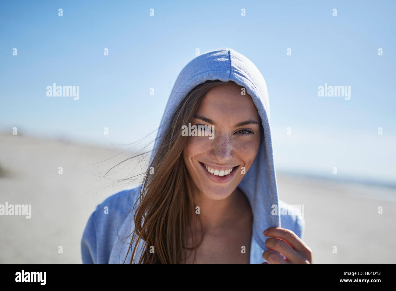Woman wearing hoodie on beach hi-res stock photography and images - Alamy
