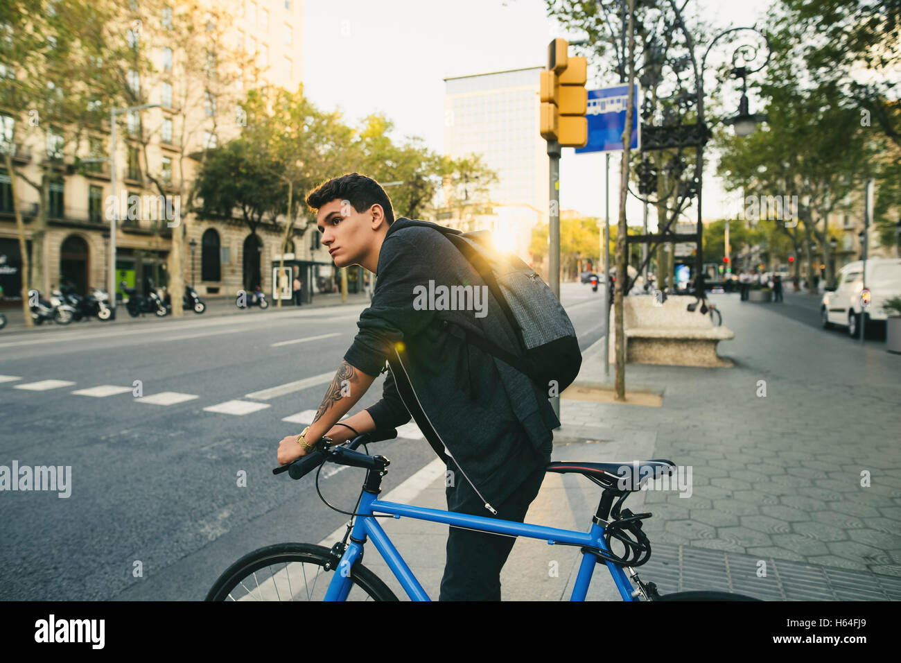 Teenager with a bike in the city Stock Photo
