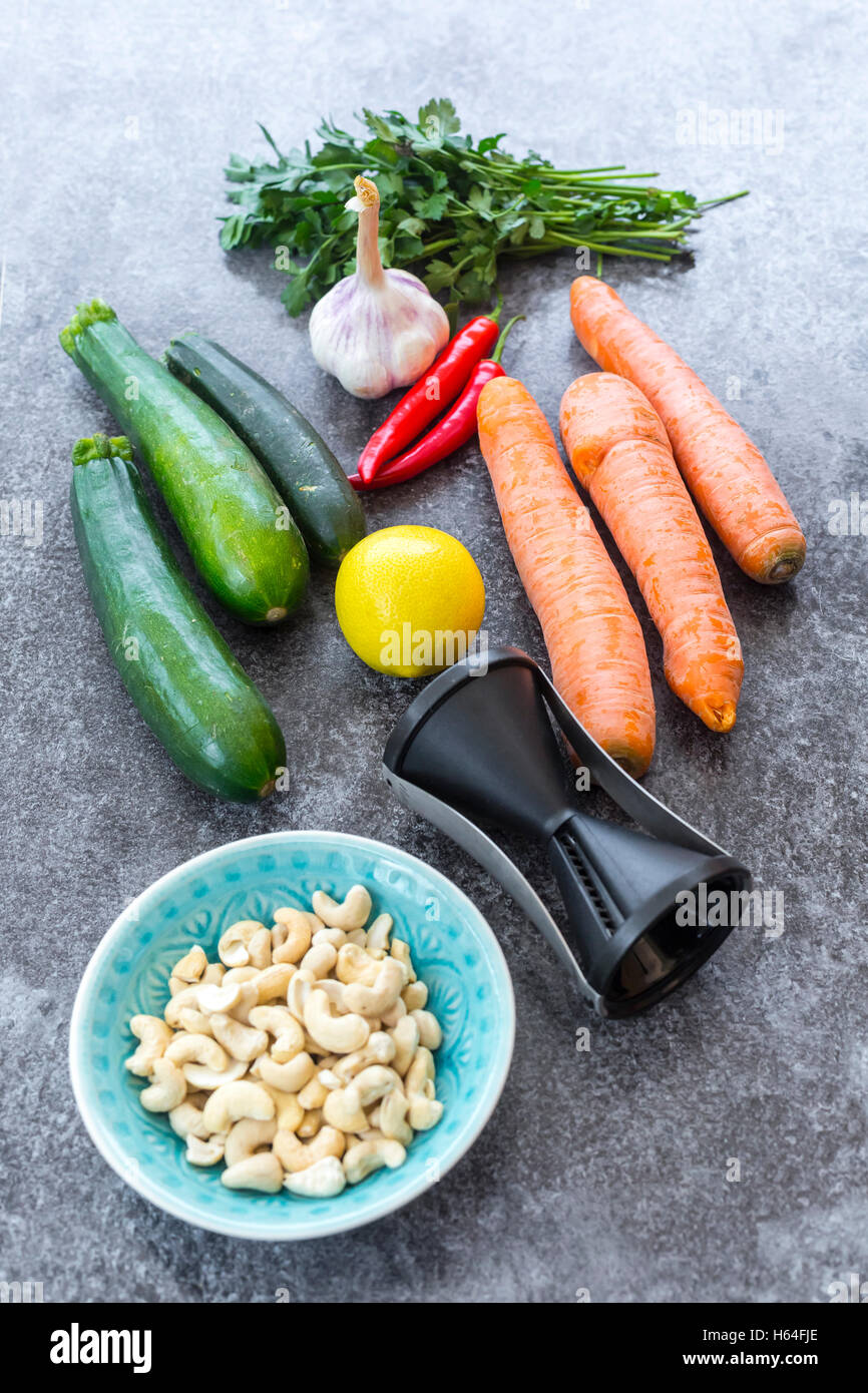 https://c8.alamy.com/comp/H64FJE/spiral-vegetable-slicer-and-ingredients-of-vegetable-noodle-salad-H64FJE.jpg