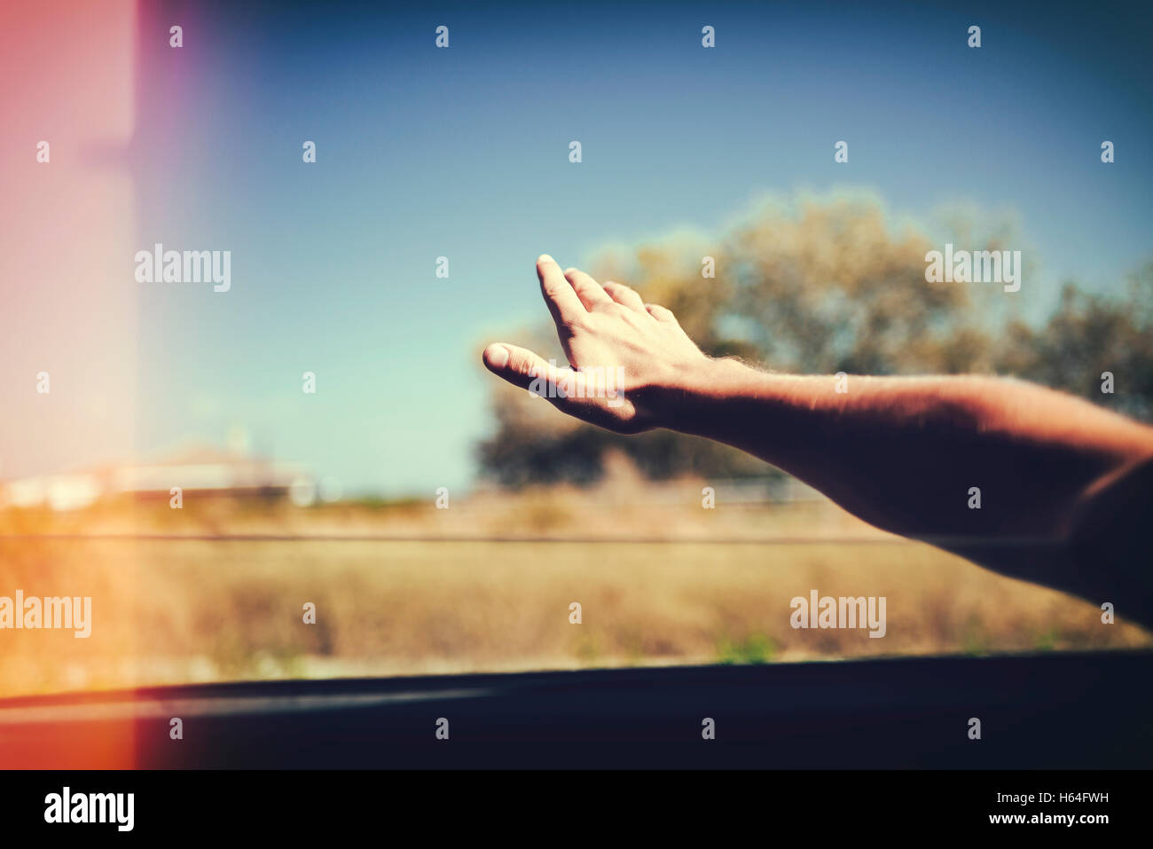 Hand of a man leaning out of car window Stock Photo Alamy