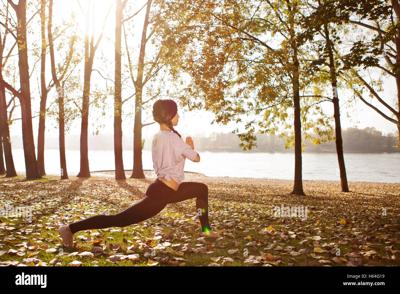 Woman in nature holding a yoga pose Stock Photo - Alamy