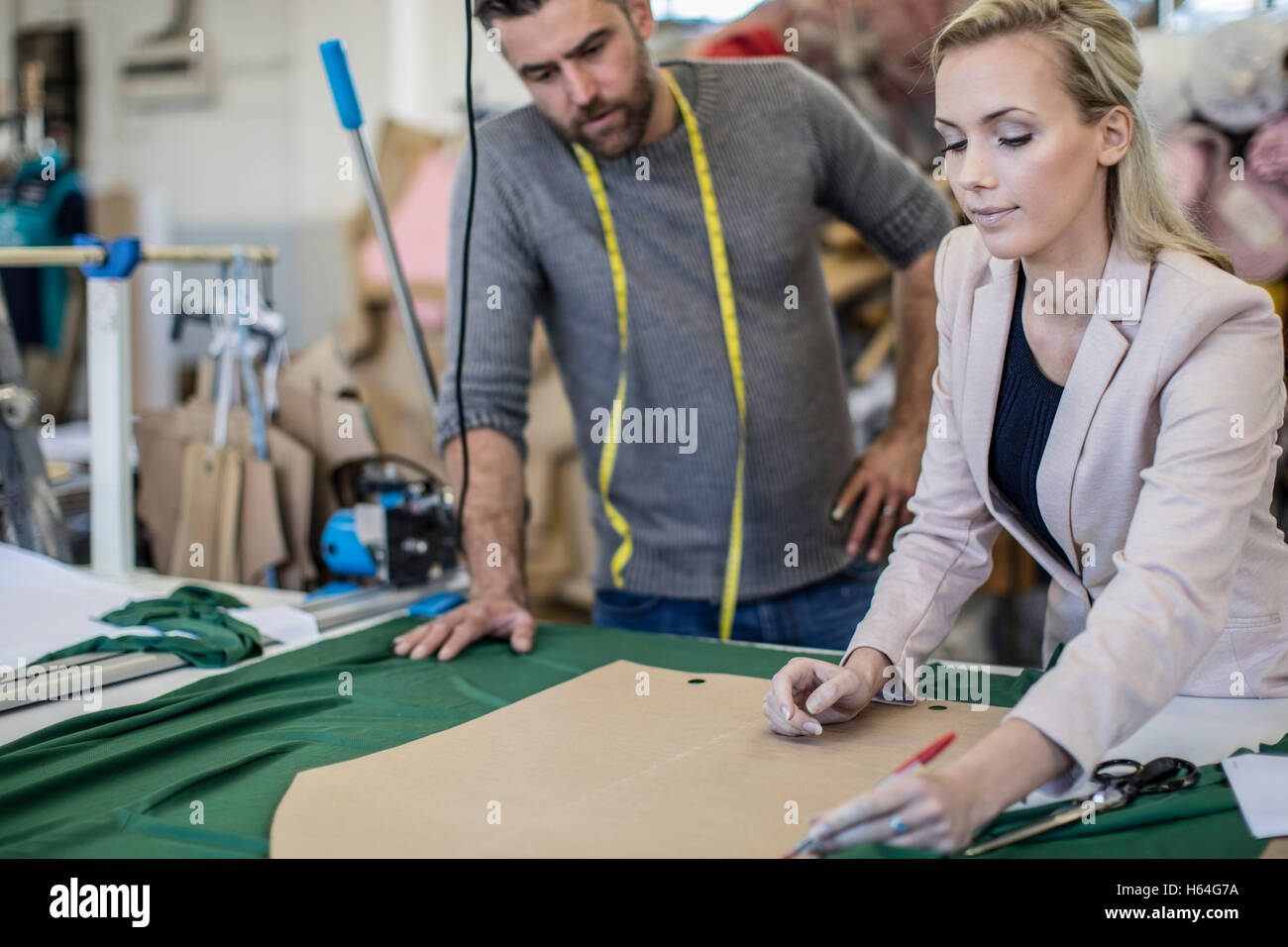 Fashion designer and tailor working together in workshop Stock Photo ...