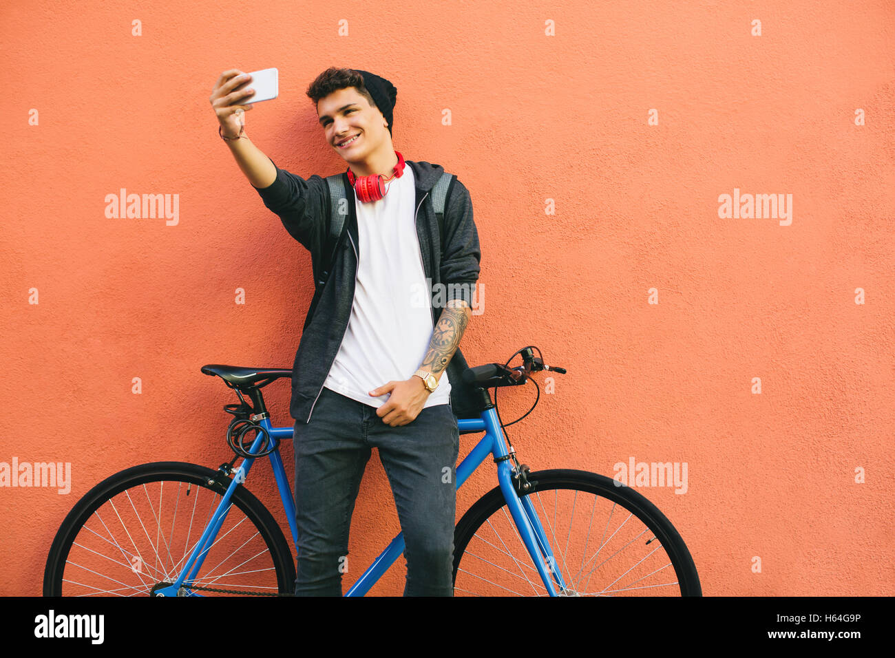 Teenager with a fixie bike, selfie, smartphone Stock Photo