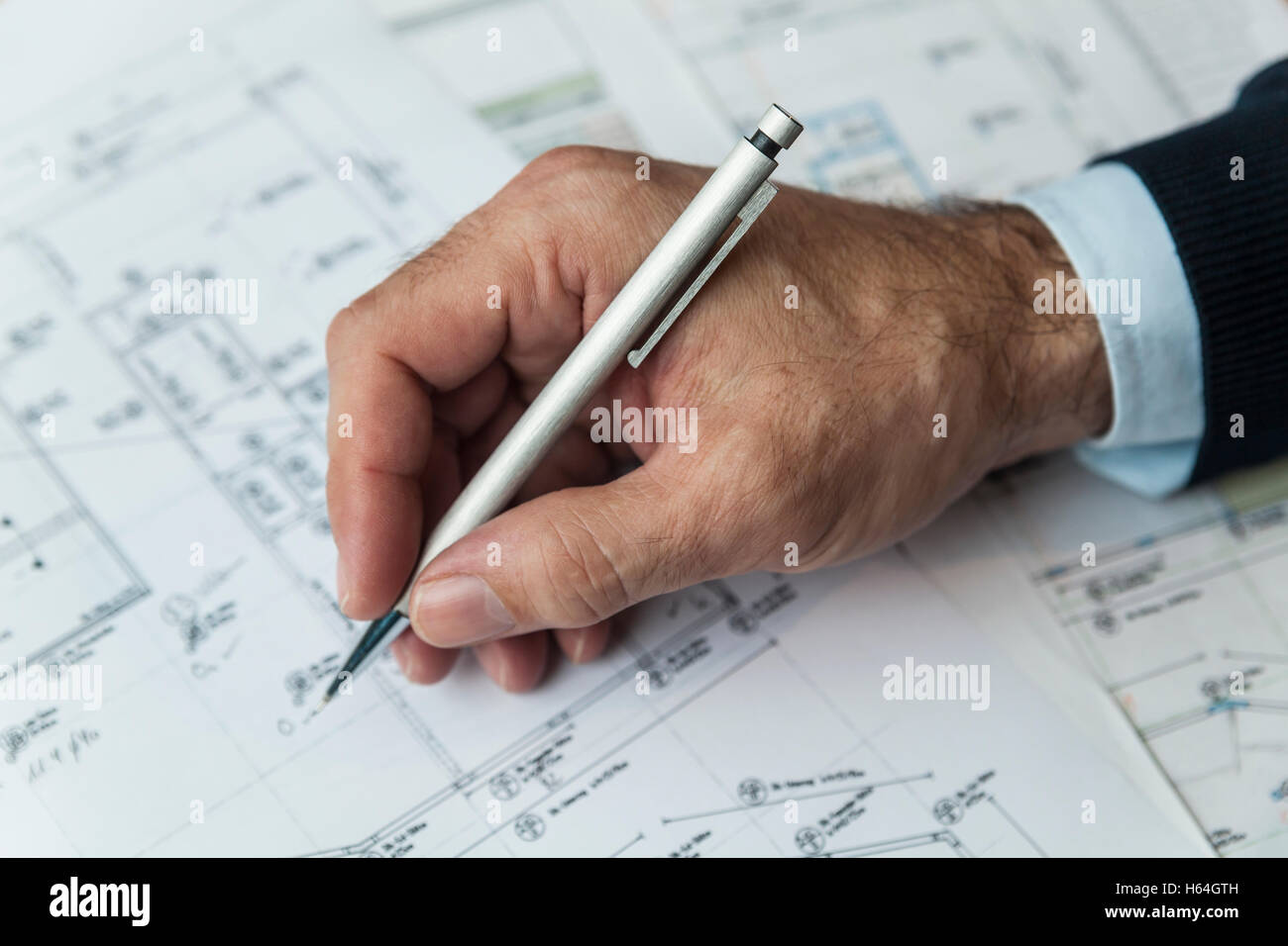 Hand of architect writing on ground plan Stock Photo Alamy