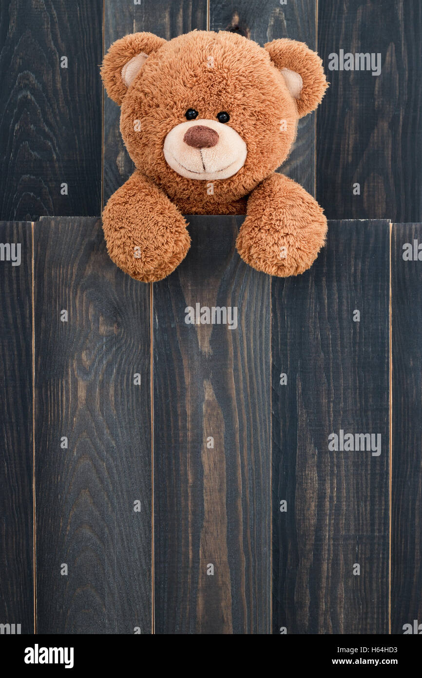 Cute teddy bear with old wood background Stock Photo - Alamy