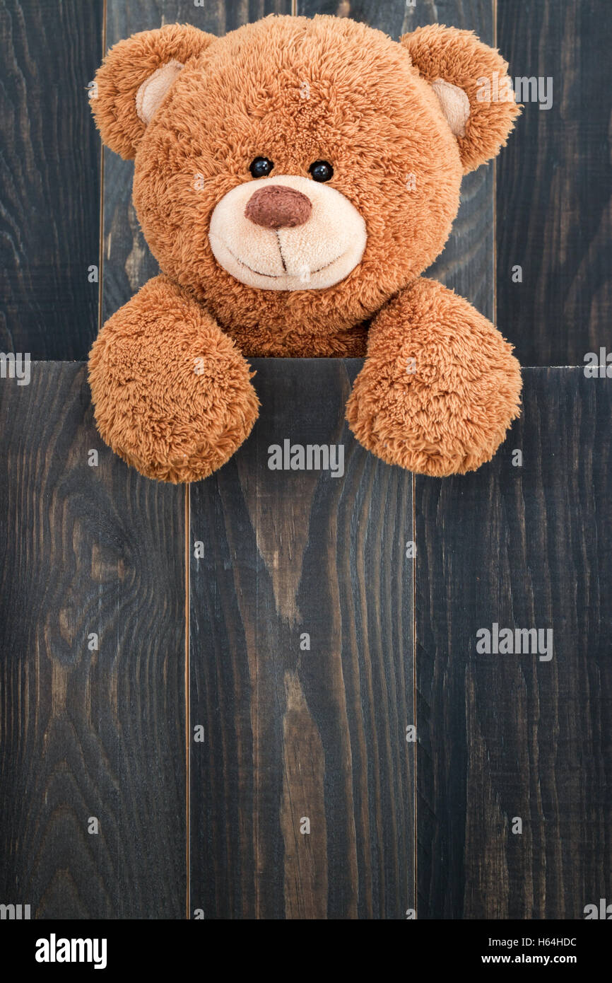 Cute teddy bear with old wood background Stock Photo - Alamy