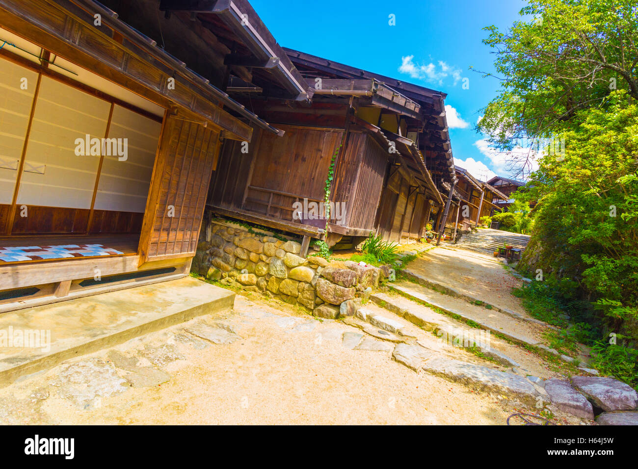 Historic Nakasendo route passes through traditional dirt road at rural village of Tsumago in Japan.  Rakish angle Stock Photo