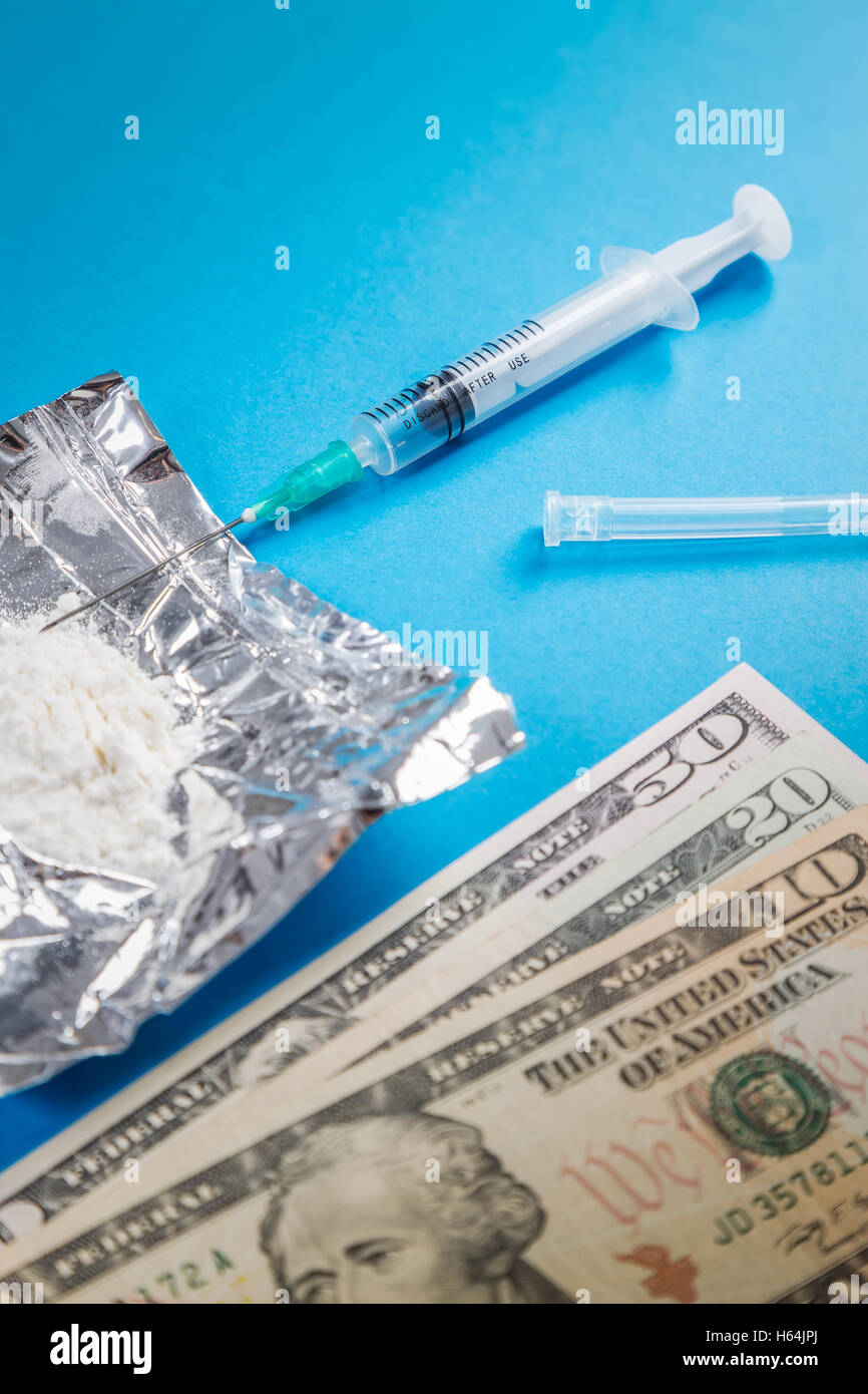 Drug syringe, narcotic dangerous,drug abuse,pay money for drugs concept. Stock Photo