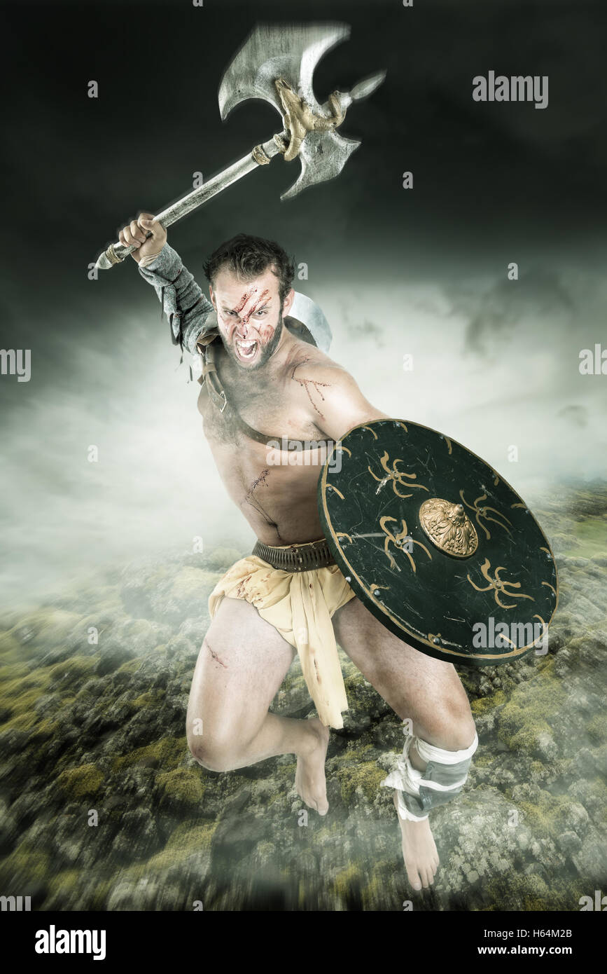 Ancient warrior or Gladiator fighting in a dark environment Stock Photo