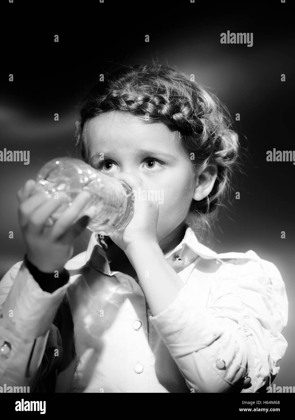 Cute little girl drinking water from the bottle Stock Photo