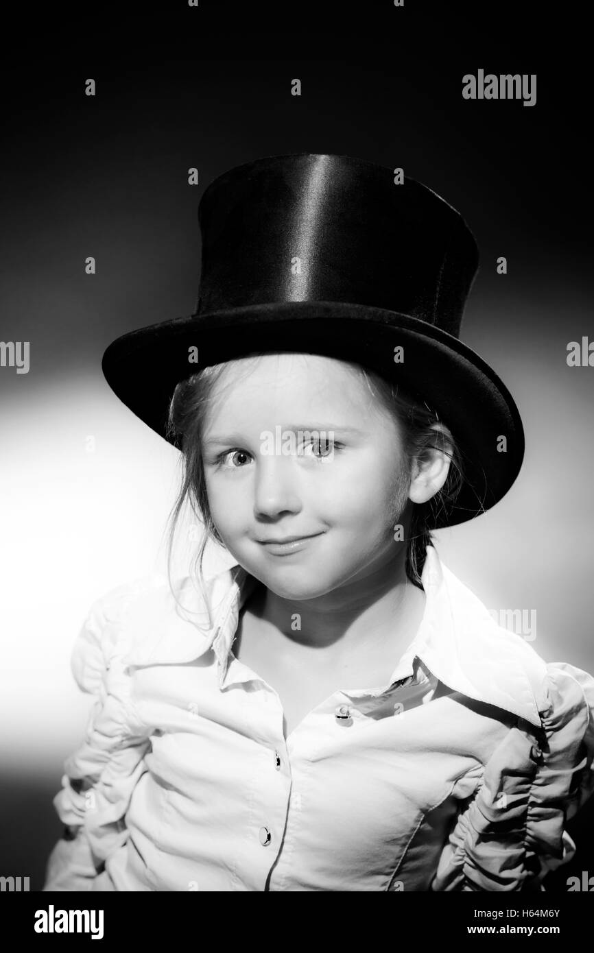 Cute little girl posing in gibus, old-style opera hat, vintage photo Stock Photo