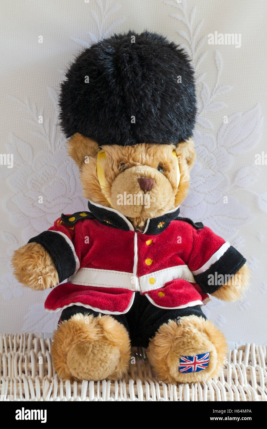 Buckingham Palace beefeater soldier guard Teddy bear soft cuddly toy sitting on wicker basket Stock Photo
