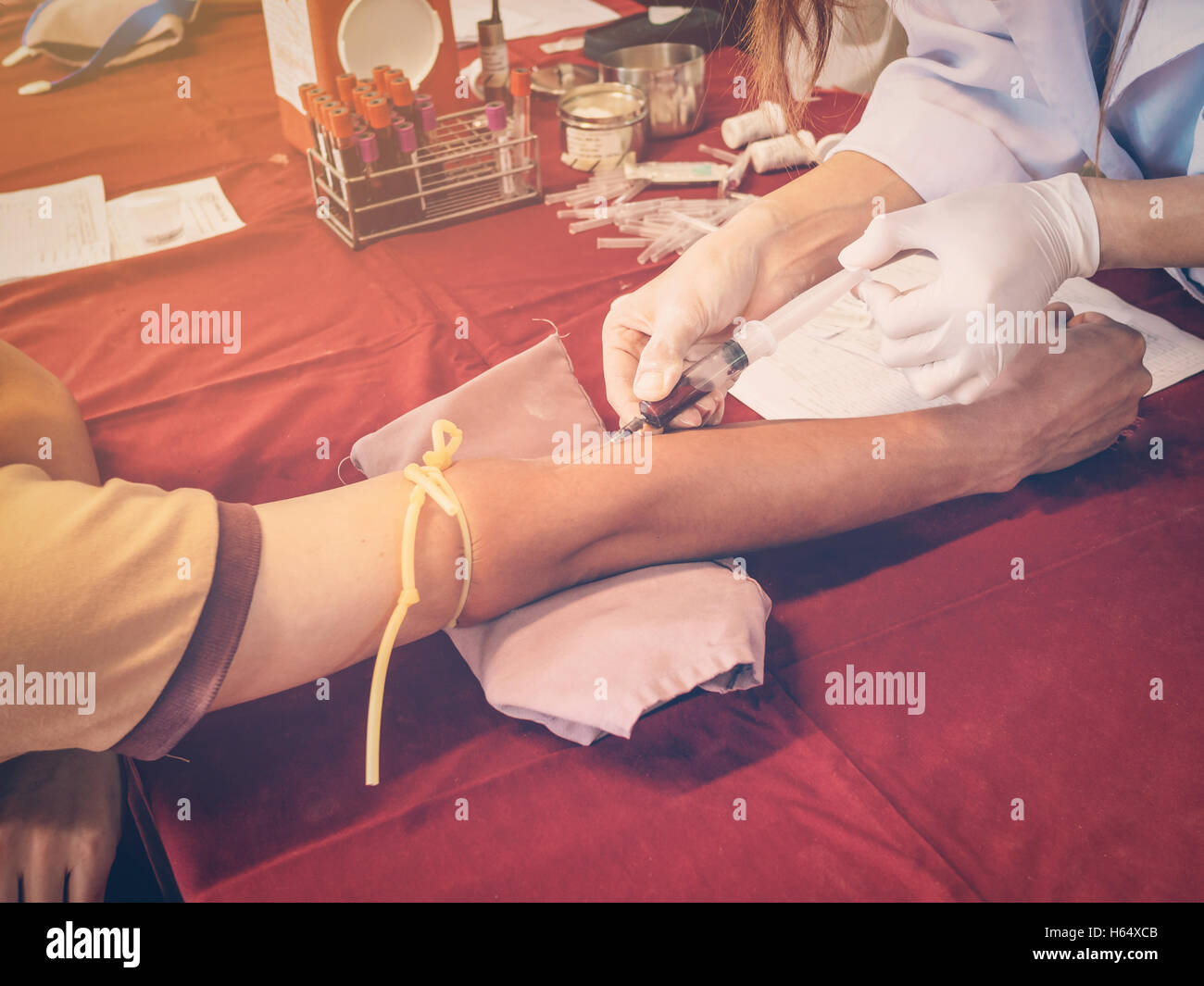 close up hand man and nurse taking a blood sample with vintage filter. Stock Photo