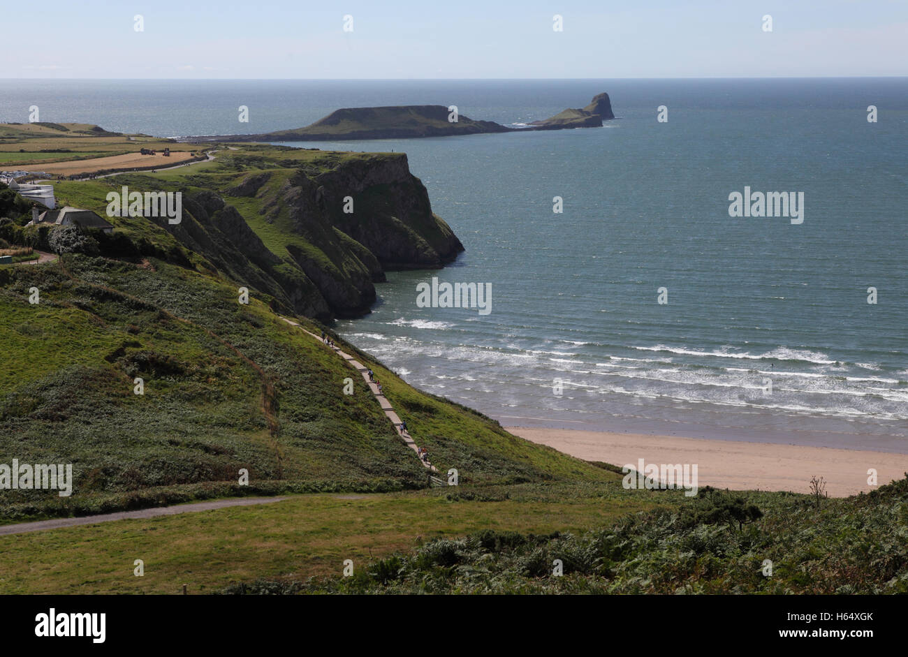 A view of Rhossili Village, the steep cliffs over Rhossili Bay, Worm's Head rock and the Celtic Sea as seen from Cefn Bryn. Stock Photo