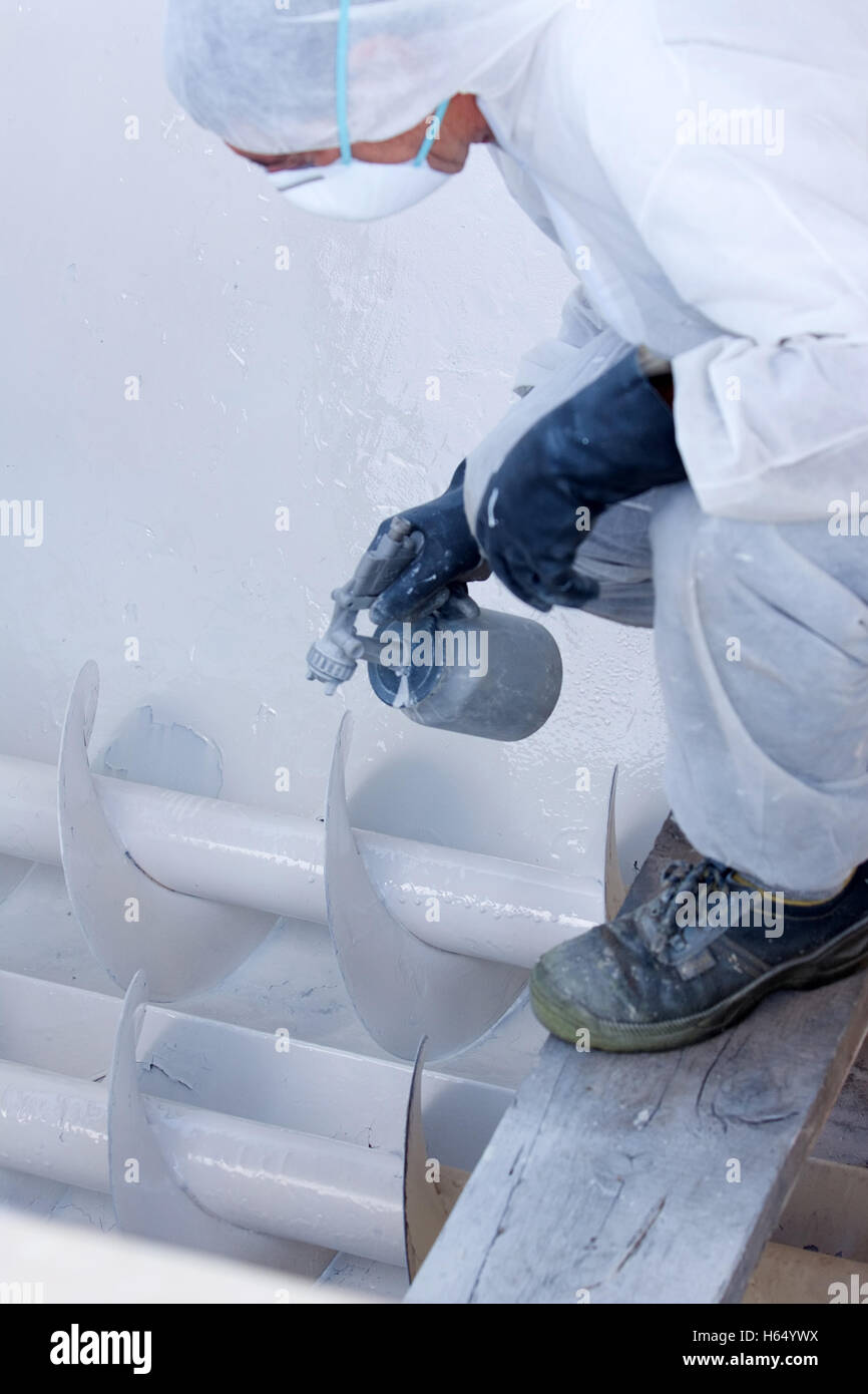 skilled worker painting industrial tool in a industry Stock Photo Alamy