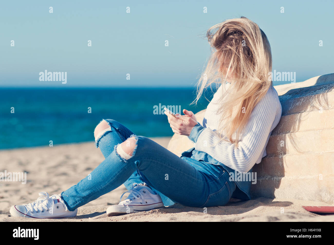 woman use mobile phone on the spring beach Stock Photo