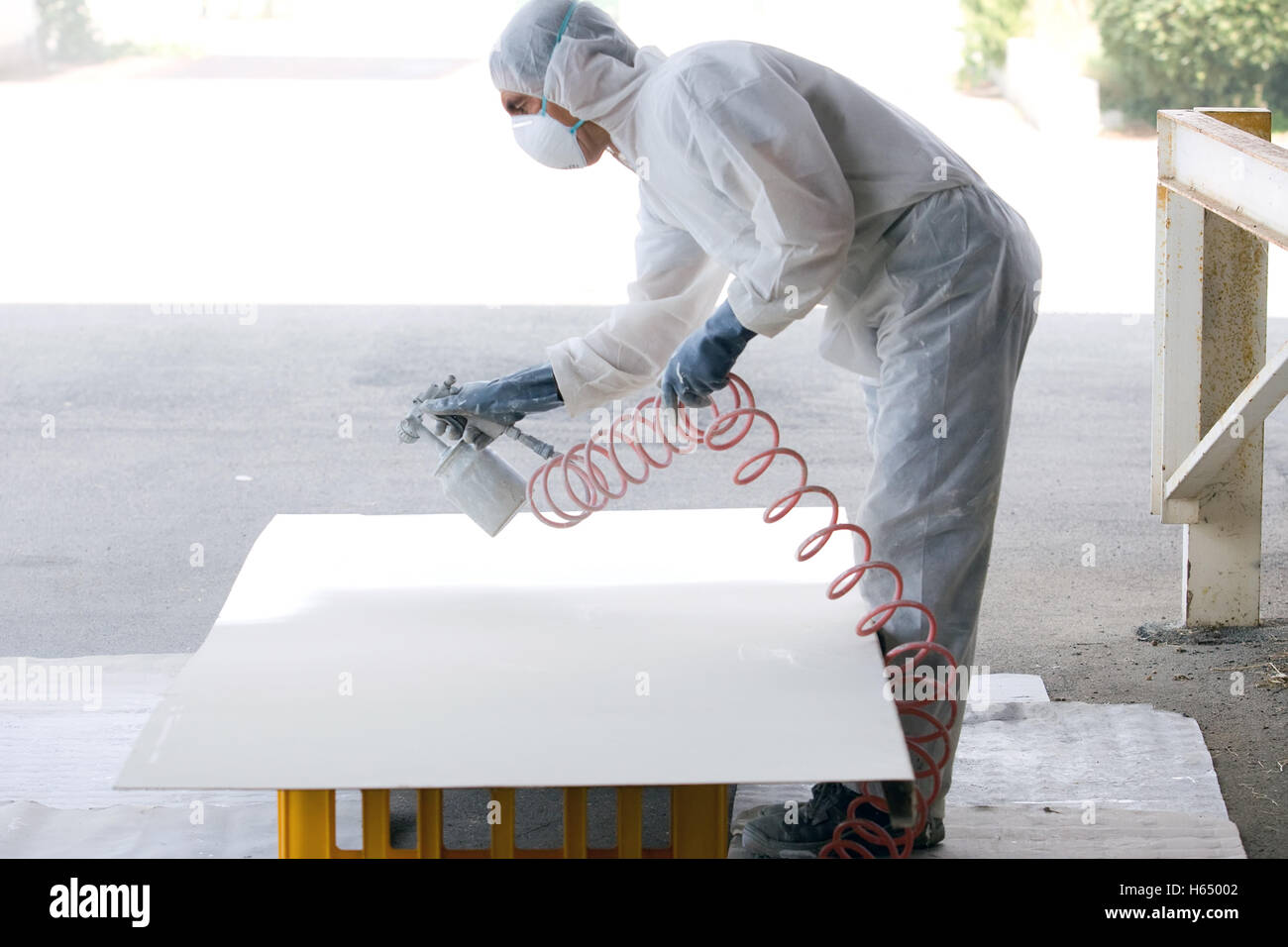 skilled worker painting industrial tool in a industry Stock Photo Alamy
