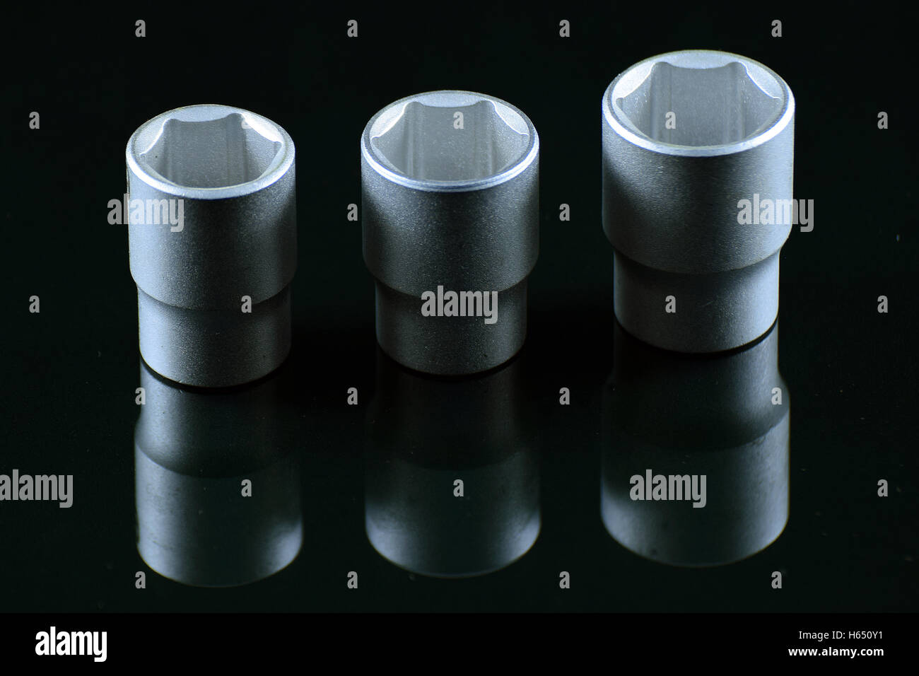 Three sockets with black background and reflection. Stock Photo